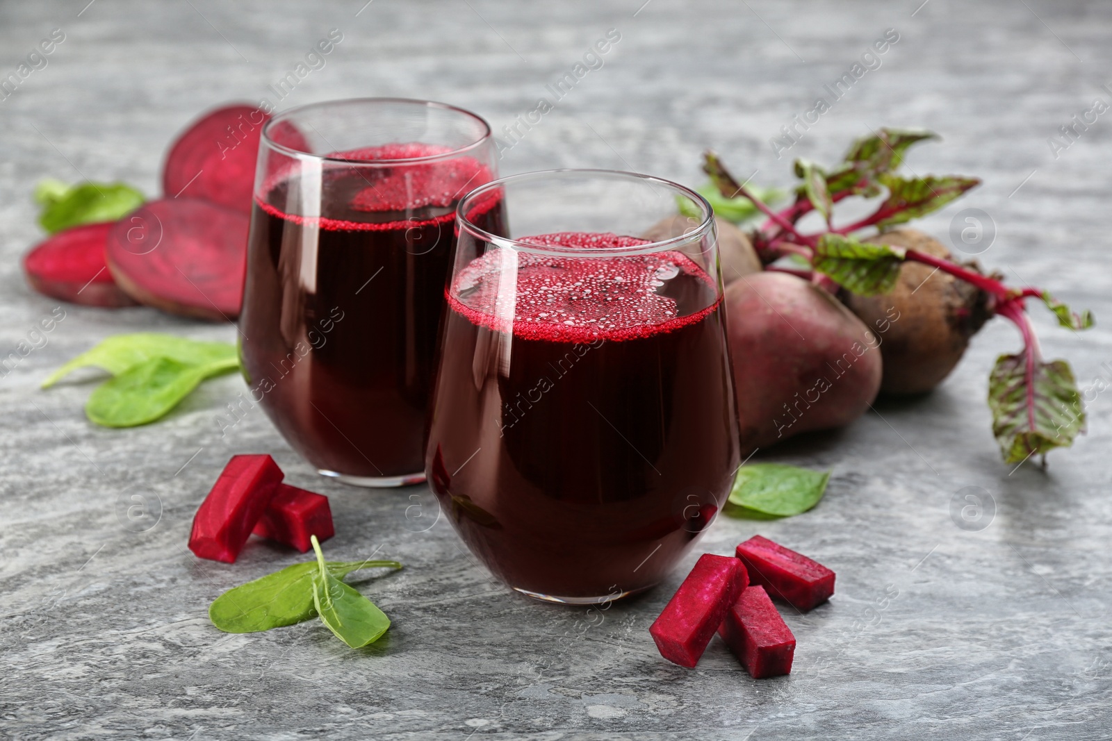 Photo of Freshly made beet juice on grey table