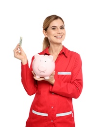 Photo of Portrait of female emergency doctor with piggy bank and money on white background