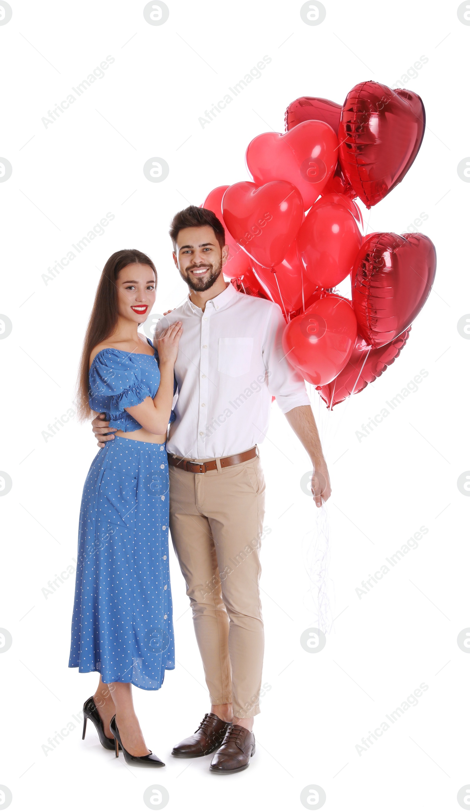 Photo of Happy young couple with heart shaped balloons isolated on white. Valentine's day celebration