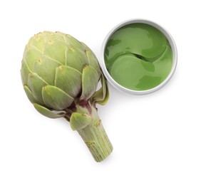 Photo of Package of under eye patches and artichoke on white background, top view. Cosmetic product