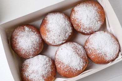 Photo of Delicious sweet buns in box on table, top view