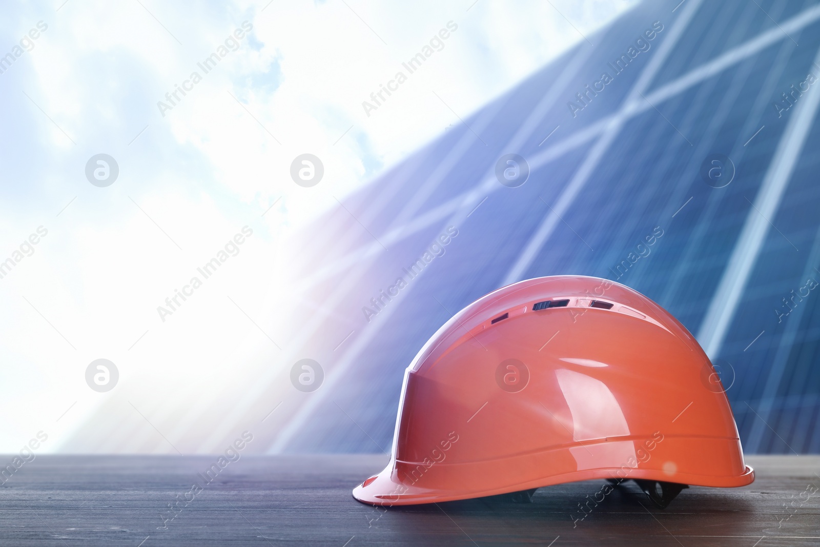 Image of Hard hat on wooden surface at construction site. Space for text 