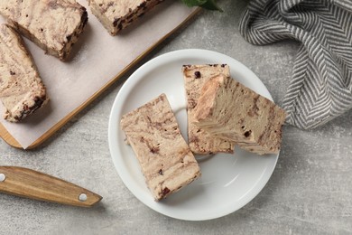 Photo of Tasty chocolate halva on grey table, top view