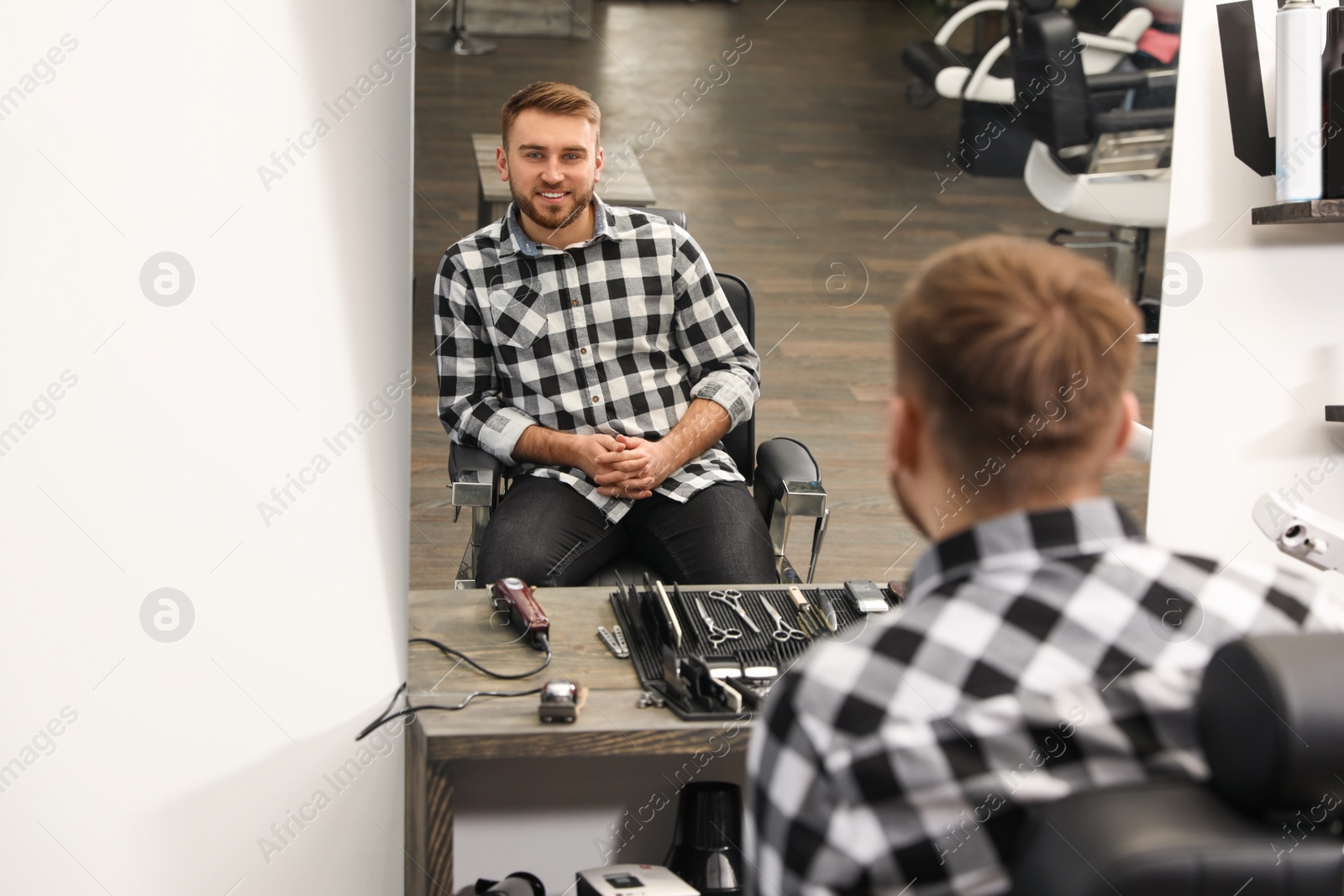 Photo of Young business owner in his barber shop