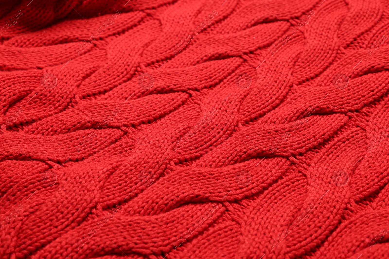 Photo of Texture of soft red knitted fabric as background, closeup