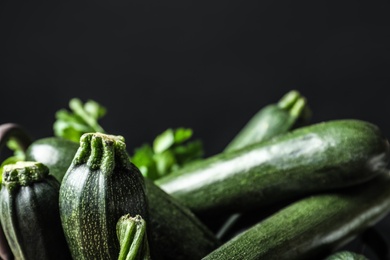 Raw green zucchinis on black background, closeup