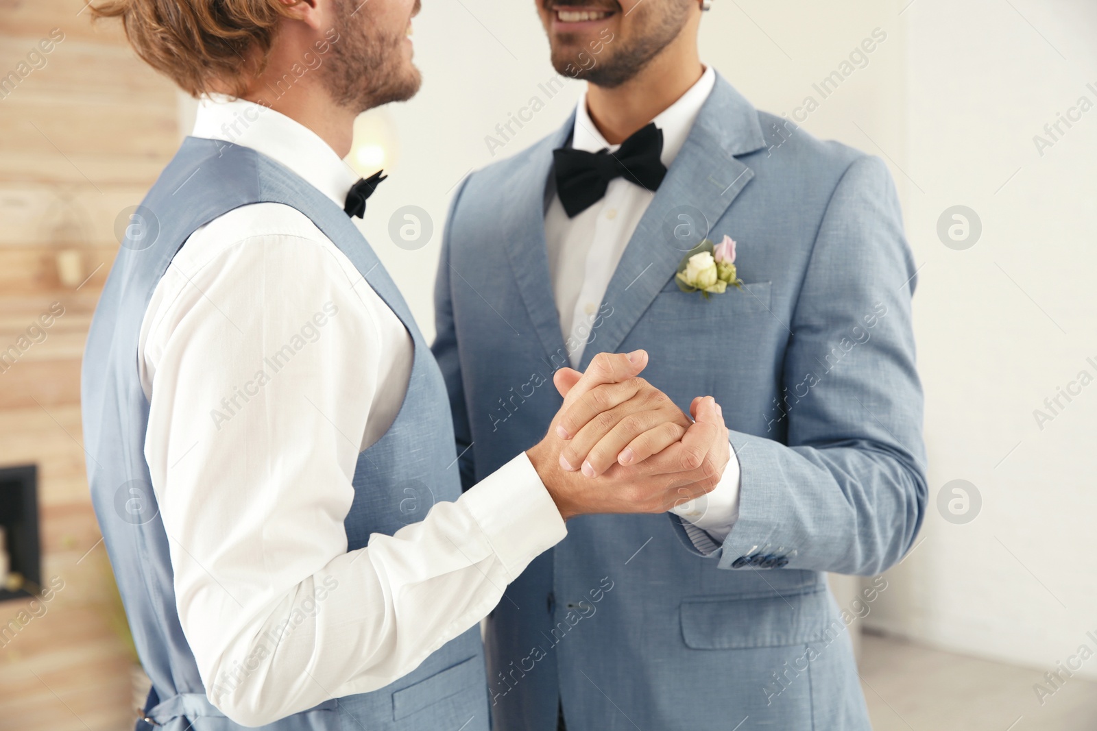 Photo of Newlywed gay couple dancing at home, closeup