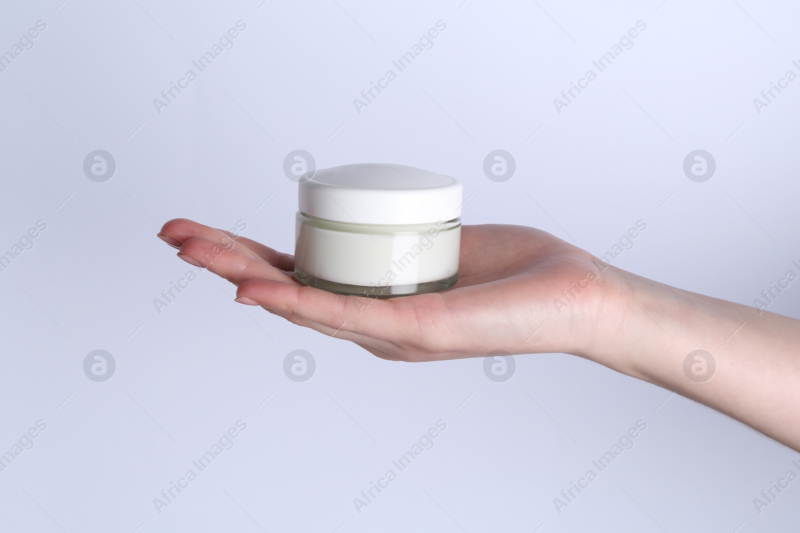 Photo of Woman with jar of cream on white background, closeup