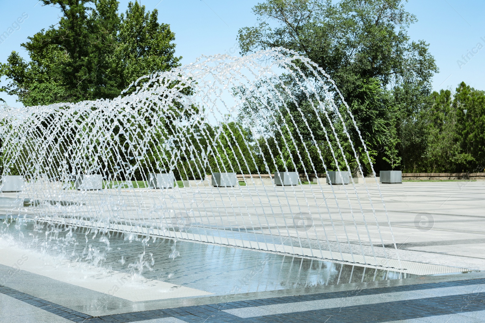 Photo of City square with beautiful fountains on sunny day