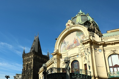 Photo of PRAGUE, CZECH REPUBLIC - APRIL 25, 2019: Municipal Hall and Powder Tower against blue sky. Space for text