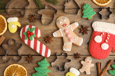 Photo of Flat lay composition with Christmas biscuits and cookie cutters on wooden table