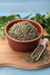 Photo of Dried parsley on light blue wooden table, closeup