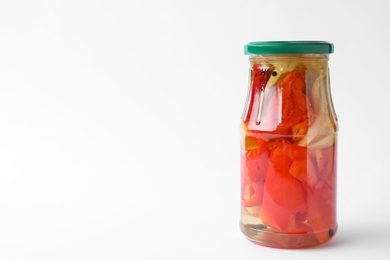 Jar with pickled bell peppers on white background