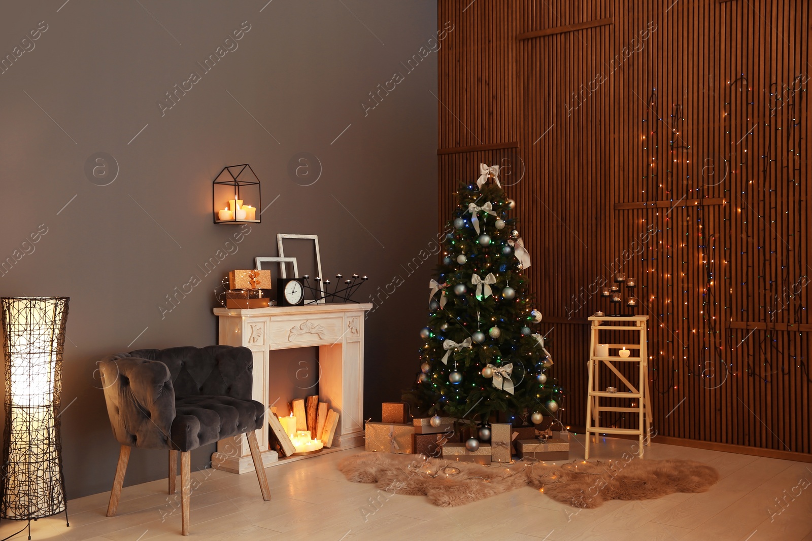 Photo of Stylish room interior with Christmas tree and decorative fireplace