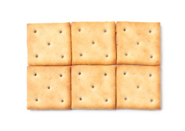 Photo of Tasty crispy square crackers isolated on white, top view