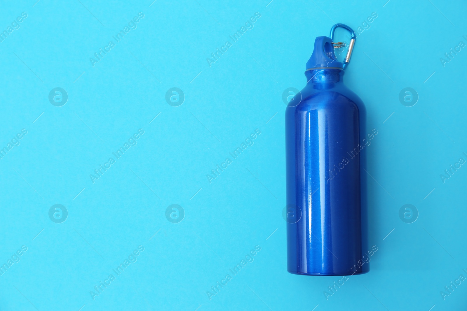 Photo of Sport bottle with space for text on color background, top view