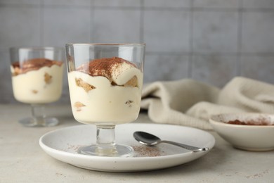 Delicious tiramisu in glass on light table