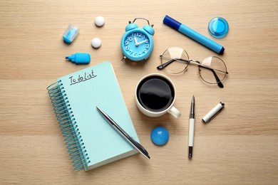 Photo of Flat lay composition with unfilled To Do list and cup of coffee on wooden table