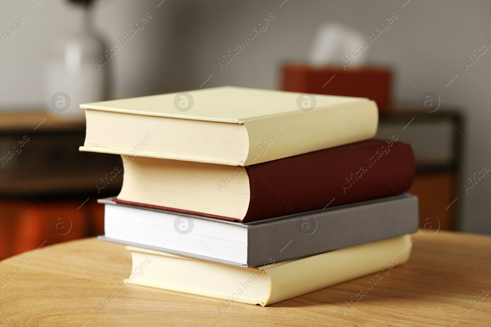 Photo of Many books stacked on wooden table indoors