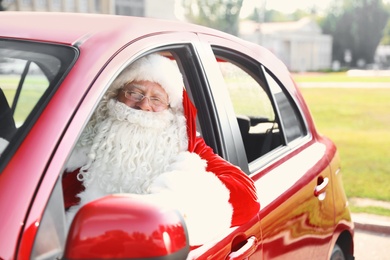 Authentic Santa Claus in car, view from outside