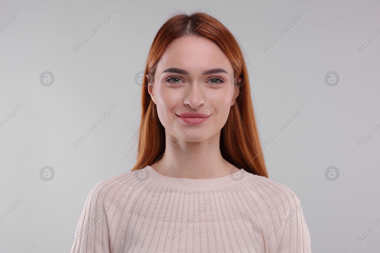 Photo of Portrait of happy woman on light grey background