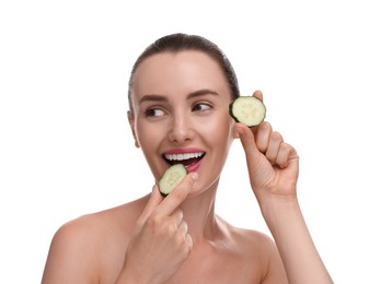 Photo of Beautiful woman with pieces of cucumber on white background