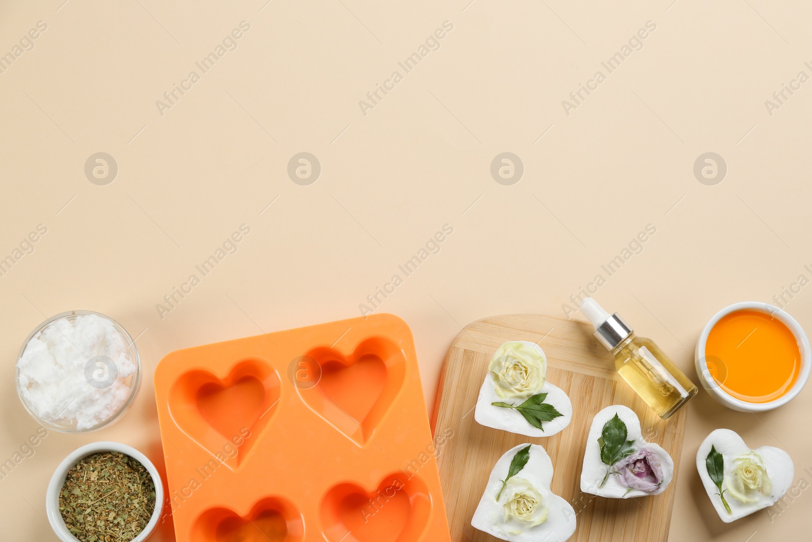 Photo of Flat lay composition with natural handmade soap and ingredients on beige background. Space for text