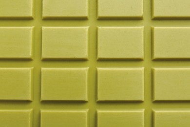 Tasty matcha chocolate bar as background, top view