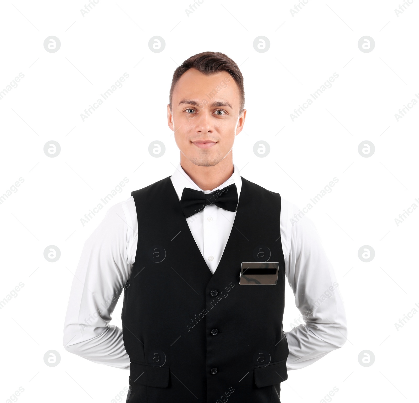 Photo of Portrait of young waiter in uniform on white background