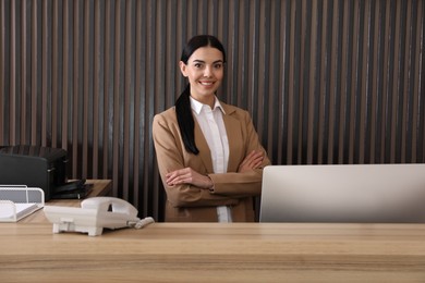 Photo of Portrait of receptionist at countertop in office