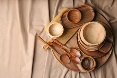 Photo of Set of wooden dishware and utensils on table, flat lay. Space for text