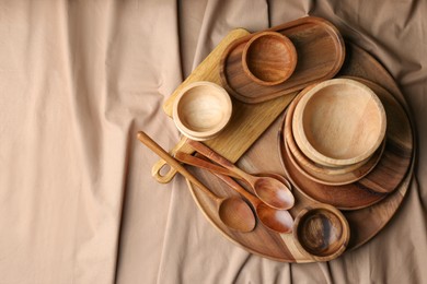 Set of wooden dishware and utensils on table, flat lay. Space for text