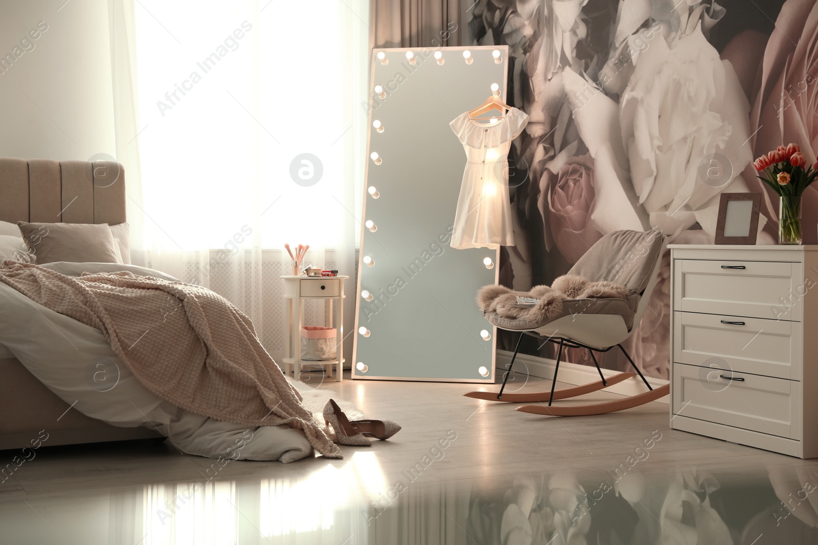 Photo of Stylish bedroom interior with lighted mirror and floral wallpaper