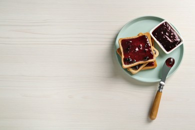 Delicious toasts with jam served on white wooden table, top view. Space for text