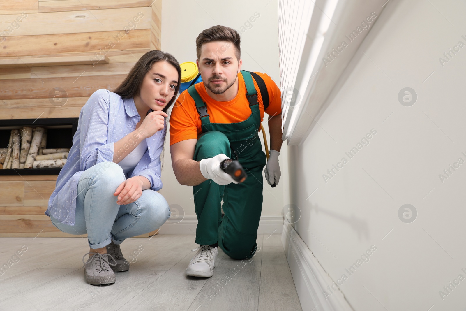 Photo of Woman showing insect traces to pest control worker at home