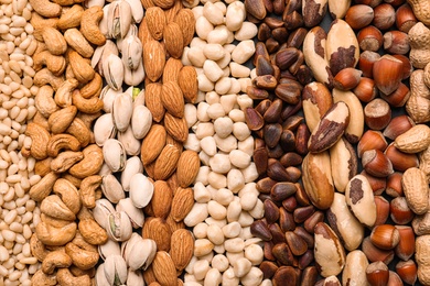 Photo of Organic mixed nuts as background, top view