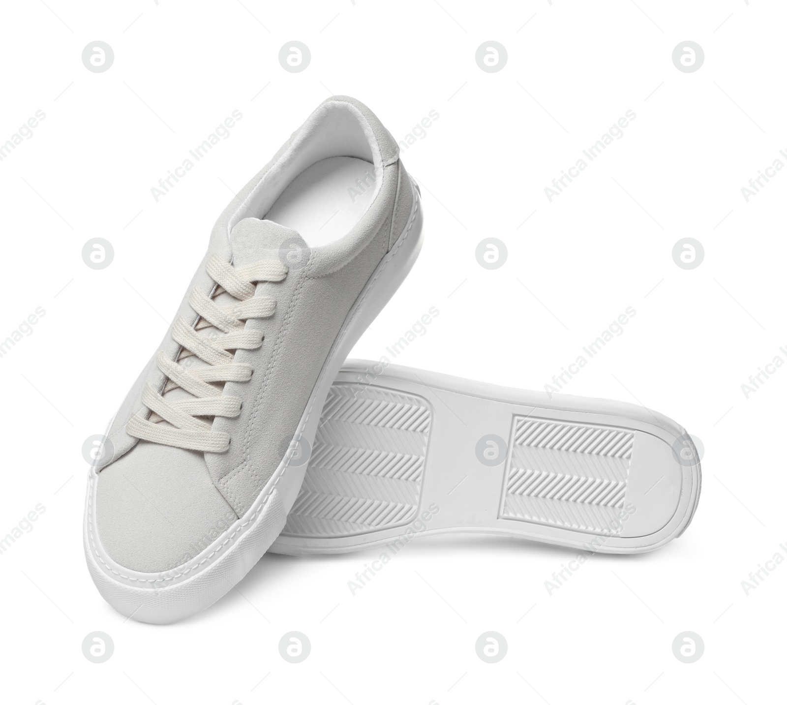 Photo of Pair of stylish beige sneakers isolated on white