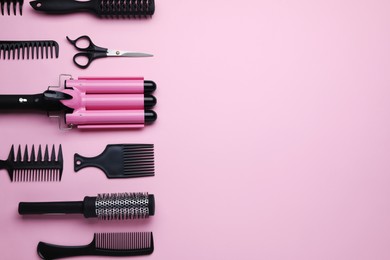 Flat lay composition with modern hair triple curling iron on pink background, space for text