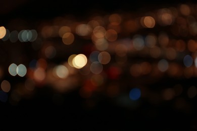 Photo of Blurred view of colorful glowing lights outdoors, bokeh effect