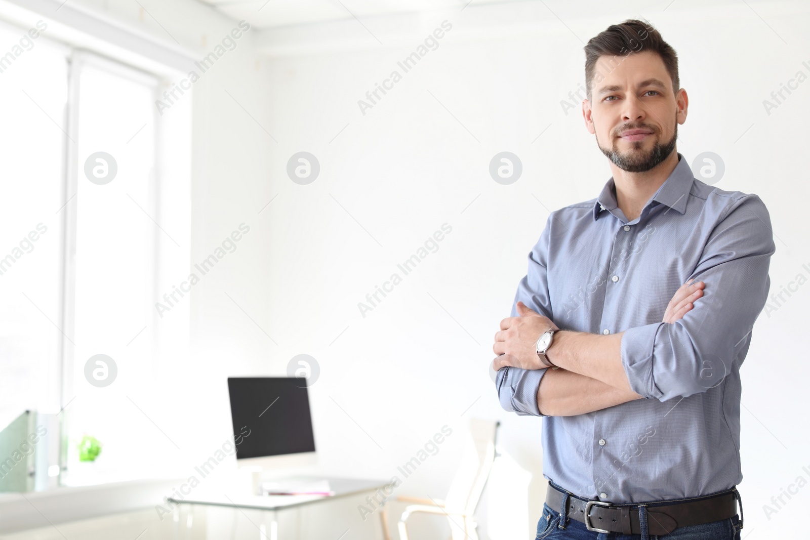 Photo of Male lawyer standing in light office