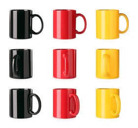 Set with different ceramic mugs on white background