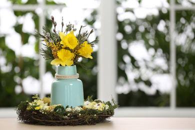 Photo of Festive Easter composition with flowers on table against blurred window, space for text