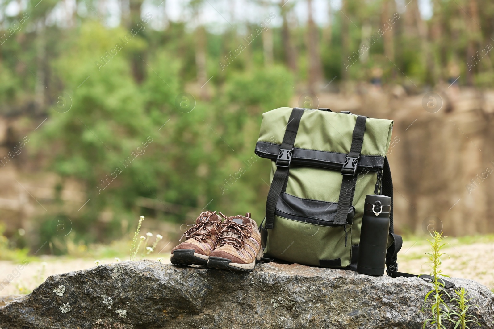 Photo of Set of camping equipment on rock outdoors