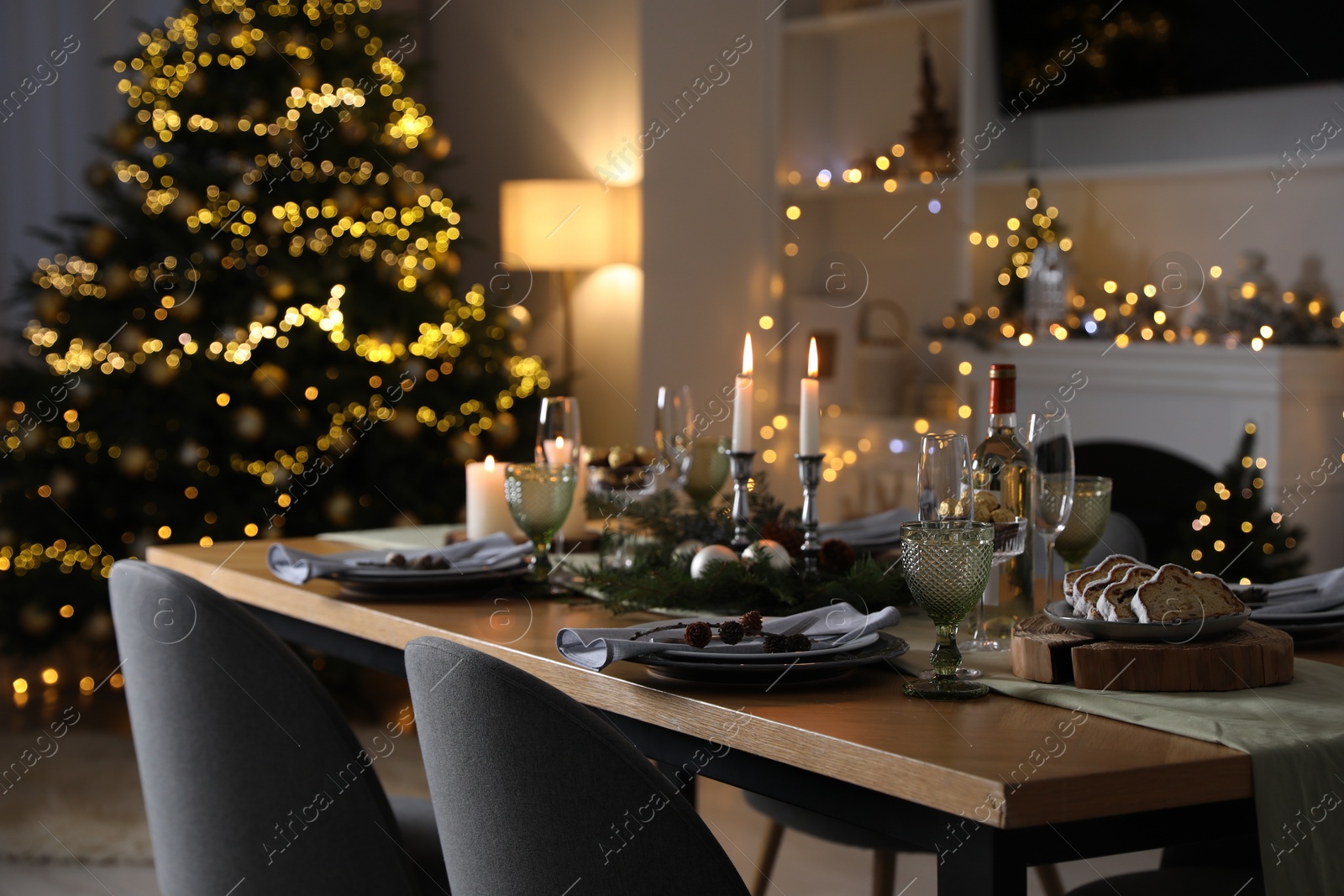 Photo of Christmas table setting with festive decor and dishware in room