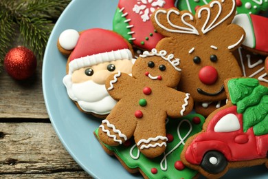 Different tasty Christmas cookies and decor on wooden table, above view. Space for text