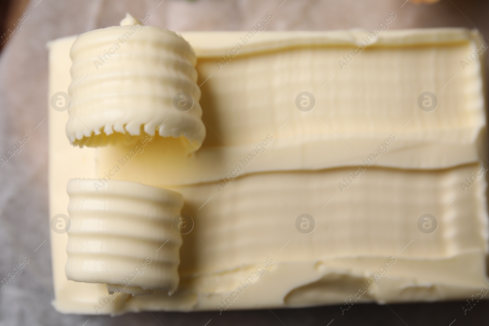 Photo of Tasty butter and curls on table, top view