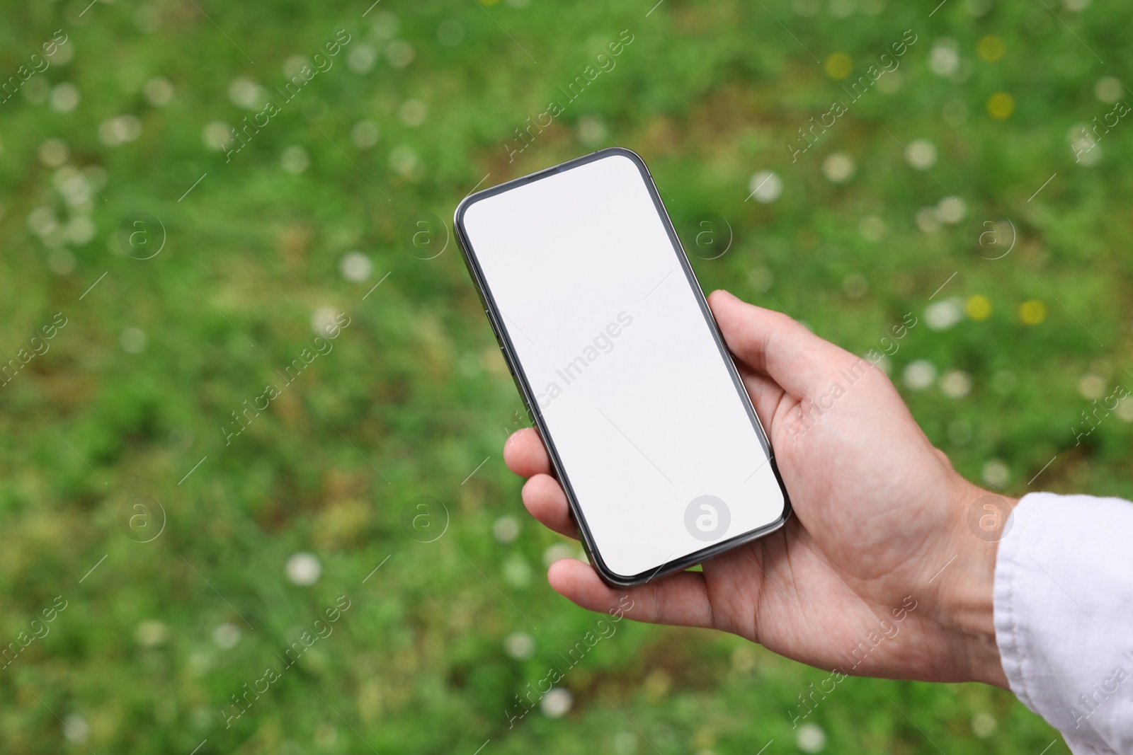 Photo of Man using mobile phone outdoors, closeup view