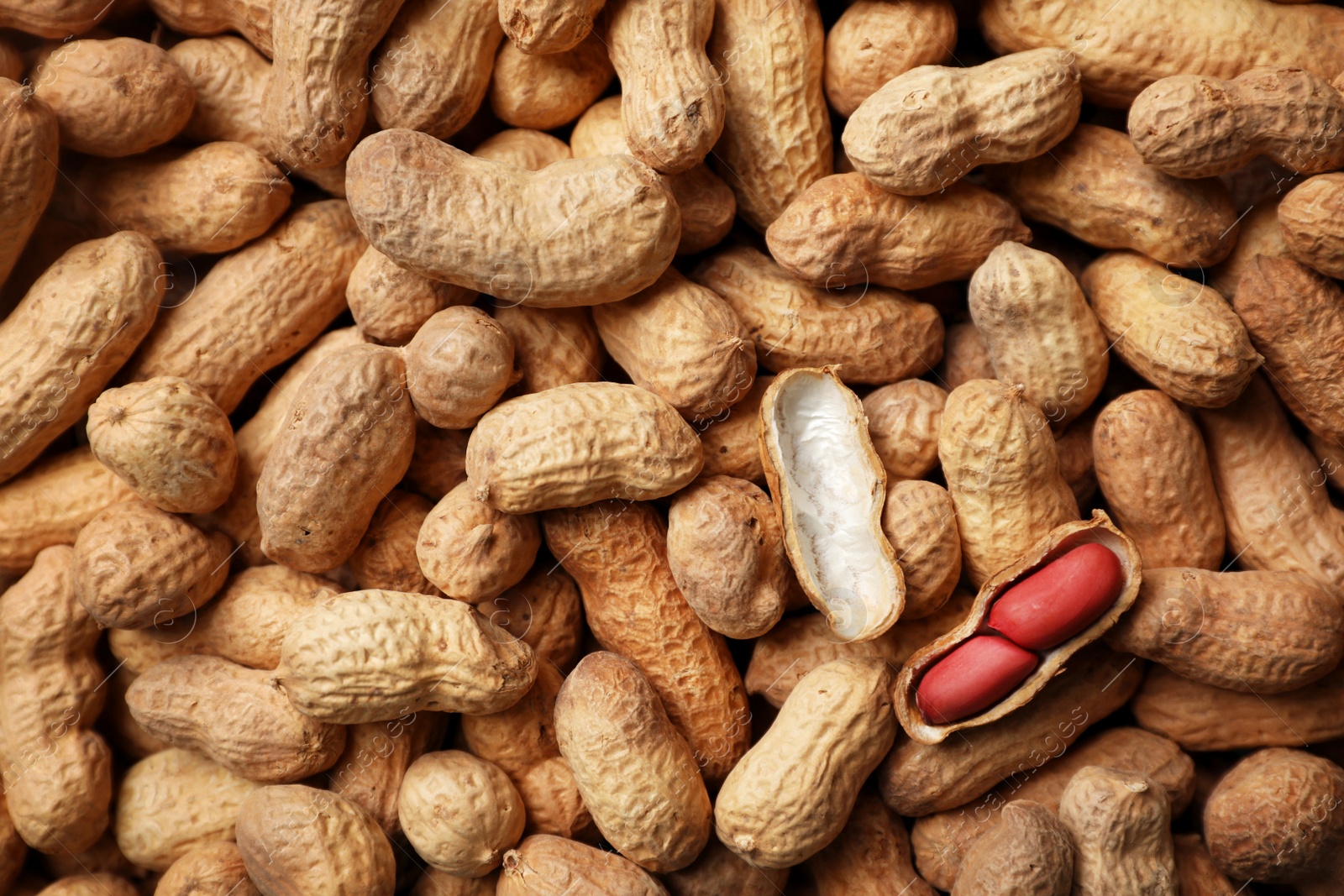 Photo of Dry peanuts in shell as background, top view. Healthy snack