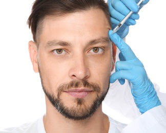 Mature man getting facial injection on white background. Cosmetic surgery concept