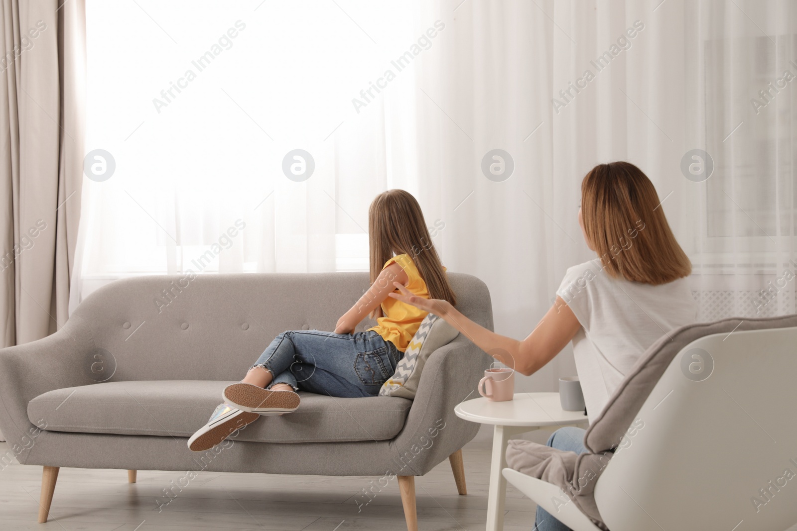 Photo of Mother scolding her teenager daughter at home